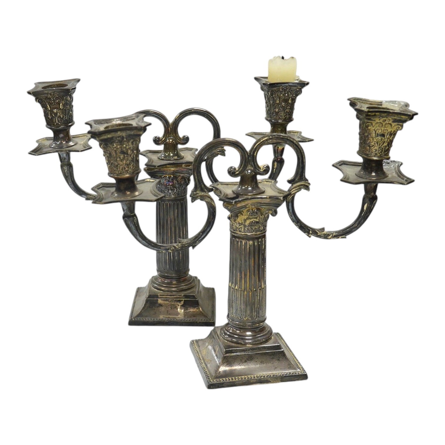 A pair of late Victorian Corinthian column dwarf candlesticks, by Martin, Hall & Co, London, 1894, 14.7cm, weighted, together with a pair of associated silver plated candelabra arms. Condition - poor to fair